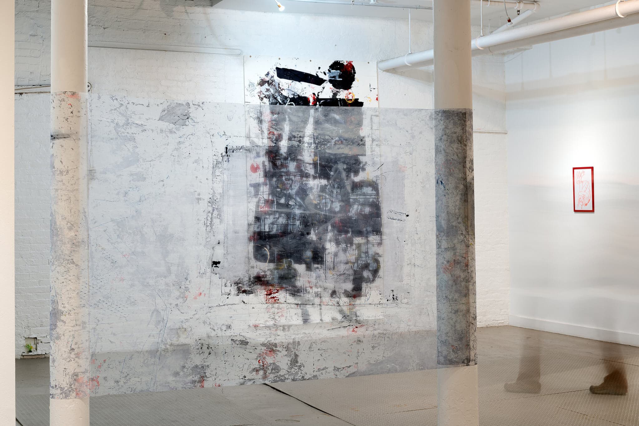 A screen and large print in a gallery space.